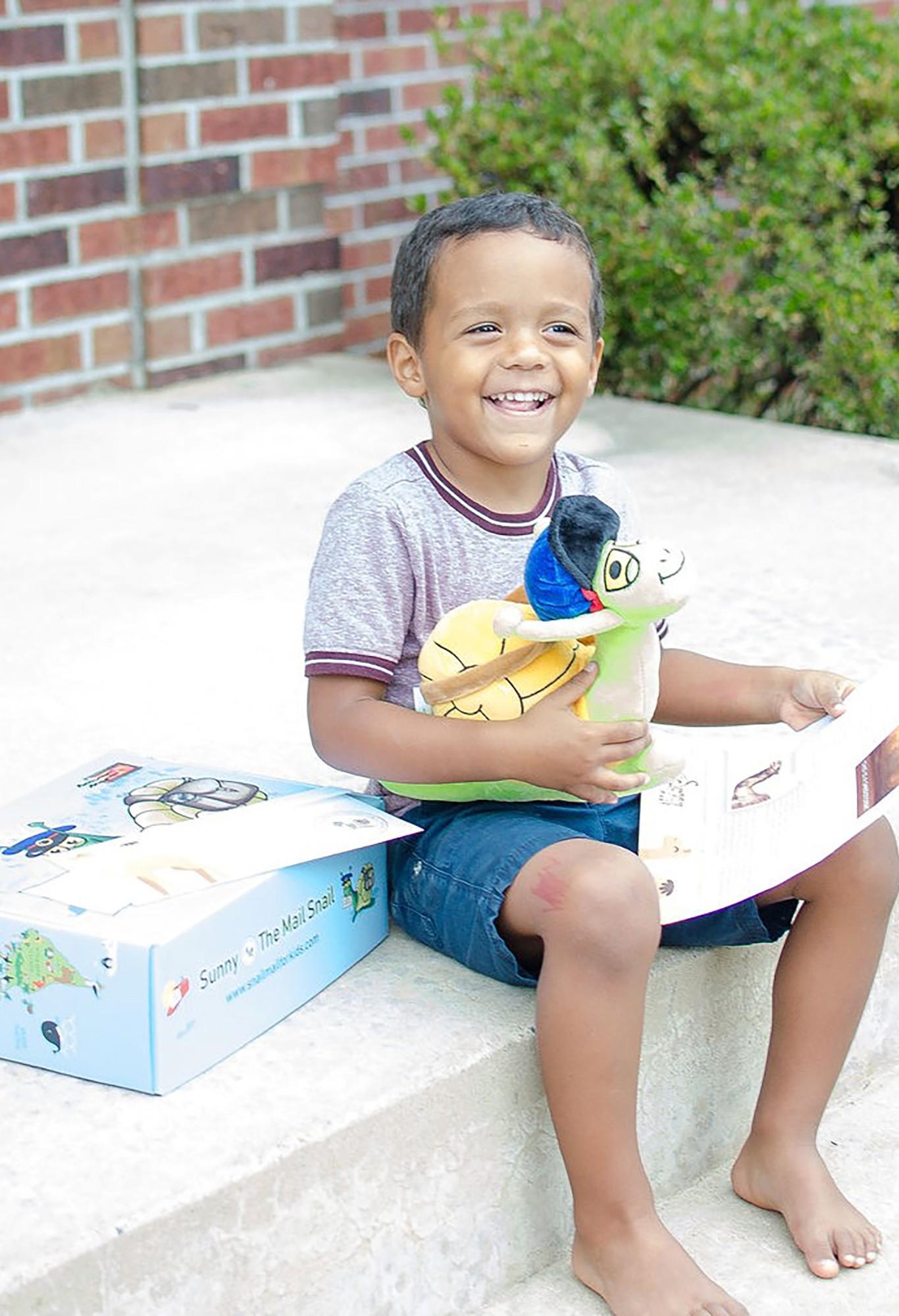 A happy boy reading his Sunny letter