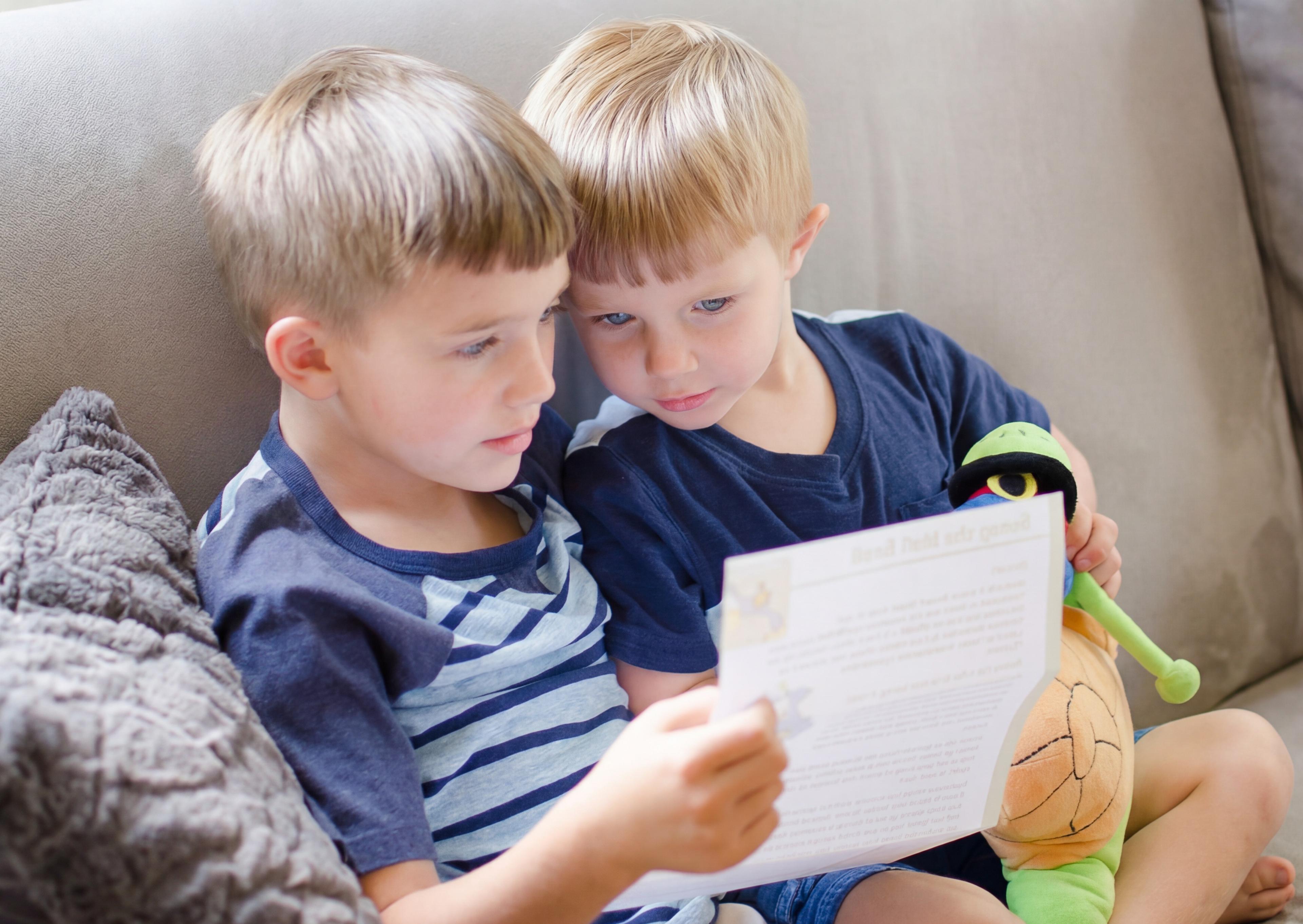 Children happily reading their letters together